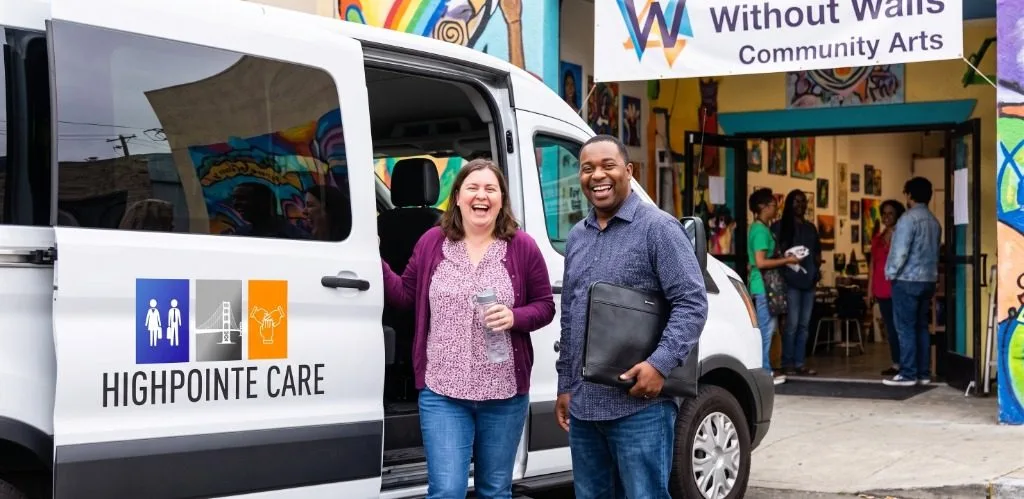 Participants standing by Highpointe Care vehicle at Community Arts center